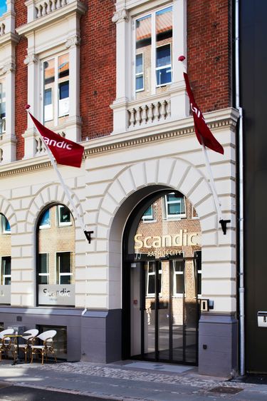 ScandicAarhusCityExteriormainentranceflagsoriginalfacade.jpeg
